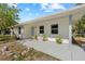 Cozy covered porch with plants, offering a welcoming entrance to the home at 215 Bradbury Ave, Oak Hill, FL 32759