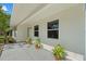 Inviting covered porch featuring potted plants, enhancing curb appeal at 215 Bradbury Ave, Oak Hill, FL 32759