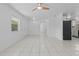 Open-concept living area featuring neutral colors and sleek tile floors at 215 Bradbury Ave, Oak Hill, FL 32759