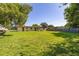 Lush backyard with a full lawn, showcasing the rear of the house, utility lines, and wooden fencing at 2222 Catherine St, Kissimmee, FL 34741
