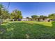 Expansive backyard with a vast lawn, complemented by fencing and nearby buildings, presenting a generous outdoor area at 2222 Catherine St, Kissimmee, FL 34741