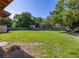Spacious backyard featuring a large grassy area and a wooden perimeter fence at 2222 Catherine St, Kissimmee, FL 34741