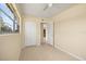 Bedroom featuring tile flooring, a ceiling fan, a window, and double closets at 2222 Catherine St, Kissimmee, FL 34741