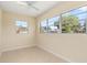 Bedroom featuring tile flooring, a ceiling fan, and windows providing views of the surrounding area at 2222 Catherine St, Kissimmee, FL 34741
