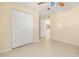 Bedroom featuring tile flooring, a ceiling fan, and double closets at 2222 Catherine St, Kissimmee, FL 34741