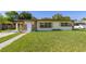 Charming single-story home featuring a well-maintained lawn and classic curb appeal on a sunny day at 2222 Catherine St, Kissimmee, FL 34741