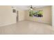 Bright, open living room with tile flooring, a ceiling fan, and a large window providing ample natural light at 2222 Catherine St, Kissimmee, FL 34741