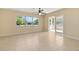 Bright living room featuring tile flooring, a ceiling fan, and glass patio doors that provide ample natural light at 2222 Catherine St, Kissimmee, FL 34741