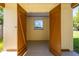 Open shed exterior with painted wood doors, interior window, and concrete floor at 2222 Catherine St, Kissimmee, FL 34741