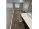 Neutral bedroom featuring wood-look flooring and a built-in vanity station at 2236 Stonington Ave # 2236, Orlando, FL 32817