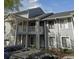 A gray two-story condo building featuring a staircase and balcony at 2236 Stonington Ave # 2236, Orlando, FL 32817