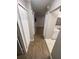 Hallway with wooden floors, white closets, and a view into other rooms at 2236 Stonington Ave # 2236, Orlando, FL 32817