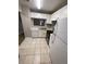 Bright kitchen featuring white appliances, tile flooring, and white cabinets at 2236 Stonington Ave # 2236, Orlando, FL 32817