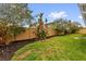 Spacious backyard featuring a well-maintained lawn, wooden fence, and mature trees for added privacy at 2344 Whispering Maple Dr., Orlando, FL 32837