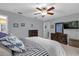 This bedroom features a ceiling fan and dresser, adjacent to bathroom at 2344 Whispering Maple Dr., Orlando, FL 32837