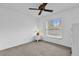 This carpeted bedroom offers a ceiling fan and a bright window at 2344 Whispering Maple Dr., Orlando, FL 32837