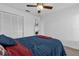 Cozy bedroom features a ceiling fan and a large closet for ample storage at 2344 Whispering Maple Dr., Orlando, FL 32837