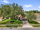 Charming single Gathering home with mature trees, well-manicured lawn, and a two-car garage at 2344 Whispering Maple Dr., Orlando, FL 32837