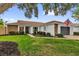 Inviting single-story home boasts lush green lawn, mature trees, and a convenient attached two-car garage at 2344 Whispering Maple Dr., Orlando, FL 32837