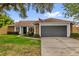 Charming single-story home featuring a brick facade, well-manicured lawn, and an attached two-car garage at 2344 Whispering Maple Dr., Orlando, FL 32837