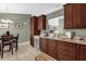 Spacious kitchen featuring dark cabinetry, granite countertops, tile flooring, and stainless steel dishwasher at 2344 Whispering Maple Dr., Orlando, FL 32837