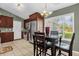 Eat-in kitchen with stainless steel appliances, dark cabinetry, tile backsplash, and bright lighting at 2344 Whispering Maple Dr., Orlando, FL 32837