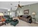 Relaxing living area features a comfortable sofa and chair, ceiling fan, and neutral carpeting at 2344 Whispering Maple Dr., Orlando, FL 32837