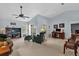 Bright living room featuring vaulted ceilings, lots of natural light, comfortable seating, and a ceiling fan at 2344 Whispering Maple Dr., Orlando, FL 32837