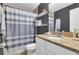 Cozy bathroom with granite counters, shower and tub with shelf, and modern gray color scheme at 2401 Mayer St, Orlando, FL 32806