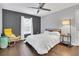 Bright bedroom with hardwood floors, a ceiling fan, and large windows for natural light at 2401 Mayer St, Orlando, FL 32806