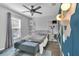 Modern bedroom with desk area, a ceiling fan, and unique wall decor at 2401 Mayer St, Orlando, FL 32806