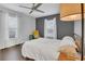 Spacious bedroom with hardwood floors, neutral walls, ceiling fan, and plenty of natural light at 2401 Mayer St, Orlando, FL 32806