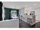Modern dining area featuring stylish lighting, dark green accent wall, and hardwood floors at 2401 Mayer St, Orlando, FL 32806