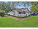 Well-maintained house with a cute front porch, landscaping, and a driveway at 2401 Mayer St, Orlando, FL 32806