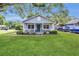 Charming single-story home with a well-manicured lawn and inviting front porch at 2401 Mayer St, Orlando, FL 32806