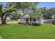 A cozy home featuring a quaint front porch and lush green lawn at 2401 Mayer St, Orlando, FL 32806