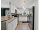 Well-lit kitchen with white cabinets, modern appliances, and a breakfast bar at 2401 Mayer St, Orlando, FL 32806