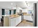 Modern kitchen with white cabinetry, stainless steel appliances, and granite countertops at 2401 Mayer St, Orlando, FL 32806
