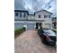 Stylish townhouse showcasing brick driveway and attached garages at 2937 Econ Landing Blvd, Orlando, FL 32825
