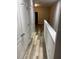 Bright hallway features wood-look flooring, white trim, and neutral walls, creating a clean and inviting space at 2937 Econ Landing Blvd, Orlando, FL 32825