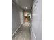 Inviting hallway with wood-look tile leading to a well-lit living space at 2937 Econ Landing Blvd, Orlando, FL 32825