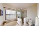 A bright bathroom with garden tub, glass shower and large window at 3044 Camino Real S Dr, Kissimmee, FL 34744