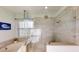 The bathroom features a frameless glass shower, garden tub, and updated fixtures at 3044 Camino Real S Dr, Kissimmee, FL 34744