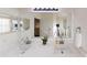 Bright bathroom featuring double sinks, large mirror, quartz countertops, and modern fixtures, creating a fresh, clean aesthetic at 3044 Camino Real S Dr, Kissimmee, FL 34744