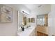 Stylish bathroom featuring a large mirror, modern vanity with sink, and ample lighting, creating a functional and appealing space at 3044 Camino Real S Dr, Kissimmee, FL 34744