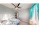Comfortable bedroom with a ceiling fan, neutral walls, and natural light, creating a relaxing and inviting atmosphere at 3044 Camino Real S Dr, Kissimmee, FL 34744