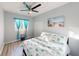 Charming bedroom featuring a ceiling fan, beach-themed decor, and inviting natural light, creating a tranquil coastal retreat at 3044 Camino Real S Dr, Kissimmee, FL 34744