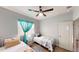 Cozy bedroom featuring twin beds, natural light, and comfortable decor, creating a welcoming and relaxing atmosphere at 3044 Camino Real S Dr, Kissimmee, FL 34744