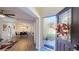Welcoming entryway with a decorative glass door, leading into the dining room with wood floors at 3044 Camino Real S Dr, Kissimmee, FL 34744