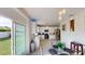 Bright kitchen featuring white cabinets, stainless steel appliances, and a sliding glass door that leads to the outdoor area at 3044 Camino Real S Dr, Kissimmee, FL 34744